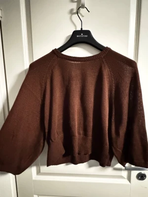 Vinröd tröja - Vinröd tröja i storlek M passar även om man har storlek S. Den har vida ärmar som slutar strax under armbågarna.