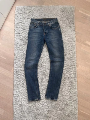 Nudie Jeans Grim Tim - Nudie Jeans - Grim Tim - Blå med feta fades - W29 L32 - Riktigt bra skick - Tveka inte att skriva vid intresse eller funderingar!