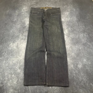 Herr mörkgrå vintage Camel Active-jeans i storlek W33 L35 - 12-619. Mörkgrå vintagejeans från Camel Active för herr, i storlek W33 L35. W/L är uppskattningar baserade på måtten.  Mått 📏 Midja: 43 cm Benslut: 23 cm Lår: 34 cm Totallängd: 108 cm Måtten hittas även på bilderna  Leverans inom 24 timmar Spara på priset och frakten genom att sätta ihop ett paket Mer information finns på min profil