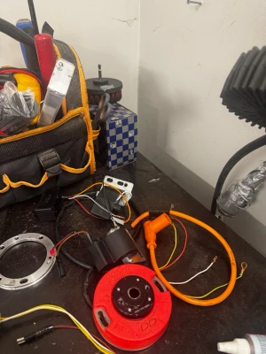 Moped trimdelar och tändsystem - Säljer ett kit med moped trimdelar inklusive cylinder, kolv, topplock i okej skick och ett komplett MVT DD tändsystem med röd tändplatta, orange kabel och tillhörande elektronik. Perfekt för dig som vill trimma eller renovera din moppe.