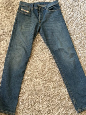 Diesel Jeans - Säljer ett par blå diesel jeans med rak och klassisk passform som är i nyskick! 