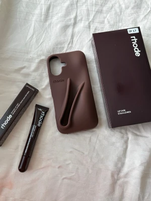 iPhone 17,17pro,16,16pro,15,15pro,14 & 13 Rhode Case with lip treatment in color Expresso and Grey - Brand new and unopened Rhode-style iPhone cases with a convenient Lip Treatment holder on the side.  🤎 Colors: Espresso & Grey 📱 Available for: iPhone 17, 17 Pro, 16, 16 Pro, 15, 15 Pro, 14 & 13 ✨ Brand new & unopened 🚚 Fast delivery  Message me if you’re interested!