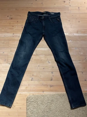 Mörkblå Replay jeans ANBASS 30 - Säljer ett par mörkblå jeans från Replay, modell ANBASS. Jeansen har klassisk femficksdesign,. Perfekta för dig som gillar stilrena och bekväma jeans med modern look.