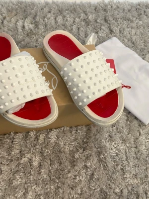 LouBoutin sandals - Beautiful Christian Louboutin sandals purchased about a year ago! Marked size EU 38, but I would say they fit more like a EU 39. The original shoe box is included.  They show some signs of wear (a little dirt), as I wore them a couple of times last summer, but they are otherwise in great condition with no damage.