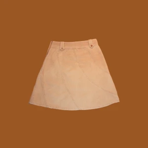 H&M Divided Khaki Corduroyed Skirt - The H&M Divided khaki corduroy skirt is a stylish and versatile piece that adds a touch of vintage-inspired charm to your wardrobe. The high-waisted design flatters your figure while providing a comfortable fit. The corduroy fabric gives the skirt a textu