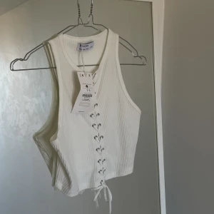 Vit topp med sömmar - Vit topp från Bershka, helt oanvänd. Cool men inte fått anvöndning för den… jag står för frakten därav endast swish som betalningsmedel 💸