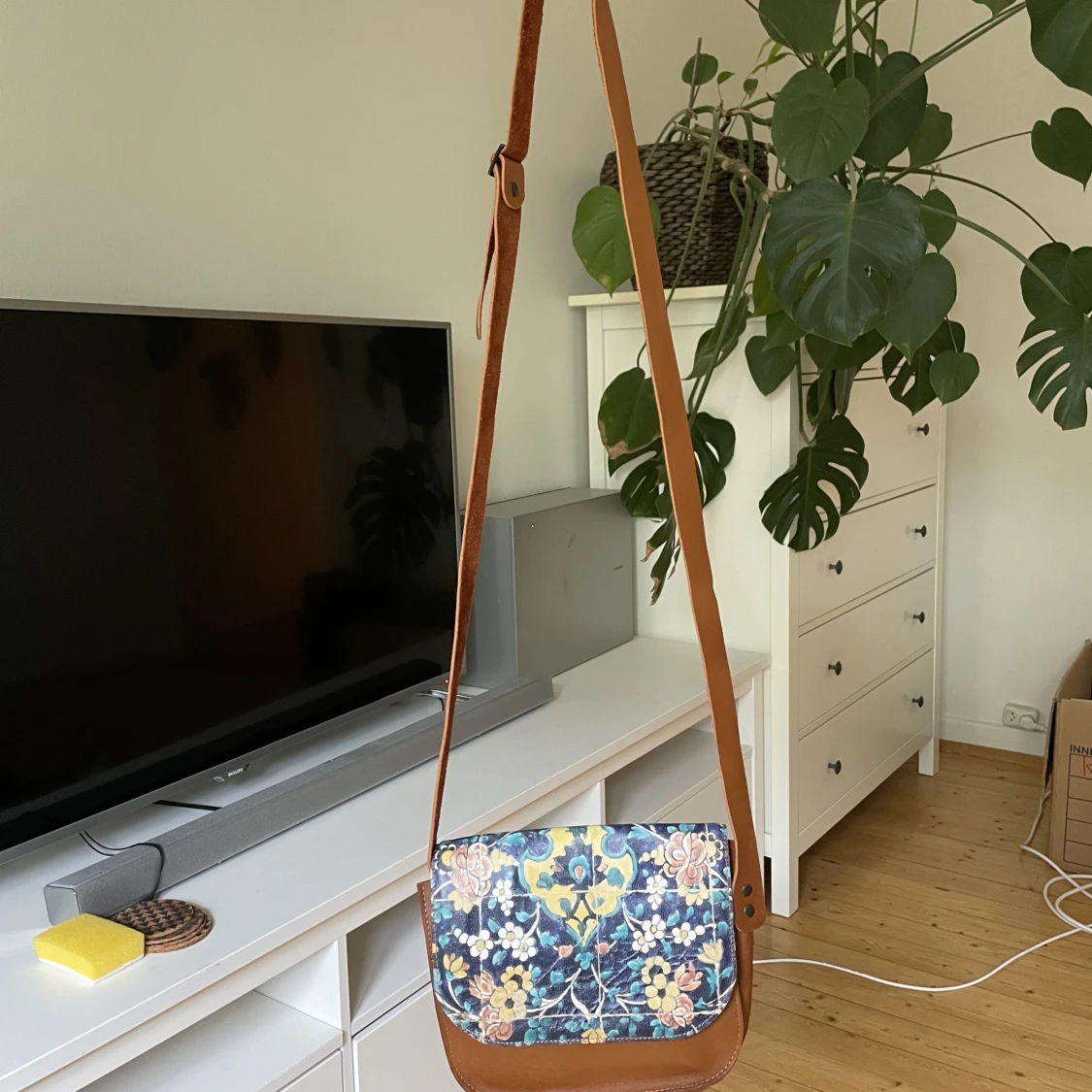 Small leather bag with a long shoulder strap