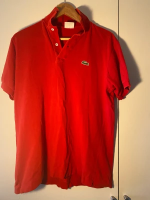 Lacoste piké  - Säljer denna fräscha Lacoste piké! Den är i väldigt fint skick  Postas bara  Betalningar sker via Swish!