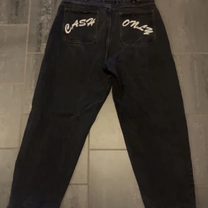  Baggy Jeans Cash Only - Baggy jeans av märket cash only. Byxorna är inköpta från junkyard för 1250kr för ungefär 2 månader sedan. byxorna är i fint skick. storlek: 34 (Medium) riktpris är 600kr eller bud 