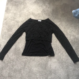 Långärmad svart tröja - Det är en långärmad tröja med blommor bröstkorgen och armarna aldrig använda 