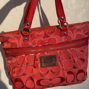 Röd/korall vintage Coach väska med Serie numer 15389. Använd men har inga större märkbara defekter. Något större än en normal handväska. Skickar gärna fler bilder och mått.