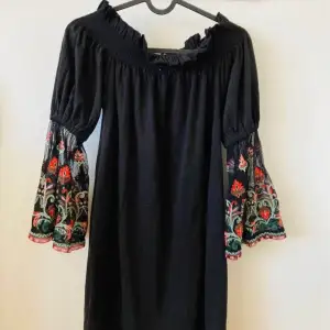 Blck dress with sheer embroidered sleeves.  Used. Worn a few times.  Smoke and pet free home. 