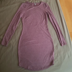 Figursydd ribbad klänning strl. XS - Figursydd kroppsnära klänning i ribbat material, aldrig använd endast provad, nyskick. Mauve färg. Sitter som en smäck på. Från Nelly trend strl. XS 