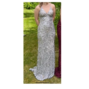 Balklänning  - Silvrig balklänning som kommer ifrån Dressingroomlinné i Göteborg. Är storlek 36/S men passar även storlek 34/XS. Använd 2 gånger och är i nyskick, alla paljetter/pärlor sitter kvar!