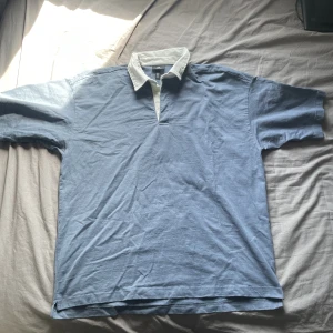 Oversized T-shirt med vit collar - Passar perfekt under en skjorta eller tjocktröja. Passar också jättebra med ett par beige, svart, blå och vita byxor 