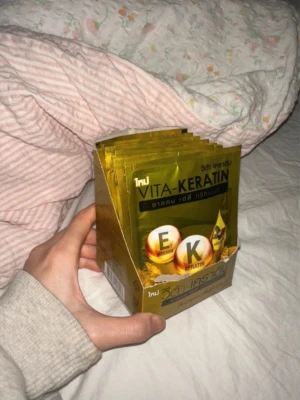 Vita-Keratin hårbehandling - Flera portionsförpackningar av Vita-Keratin hårbehandling i guldiga påsar. Innehåller vitamin E och keratin, perfekt sopackade i en kartong. Smidiga att använda för att boosta hårets styrka och glans. Säljer hela paketet så 10 x20ml. Köpt i Thailand😊