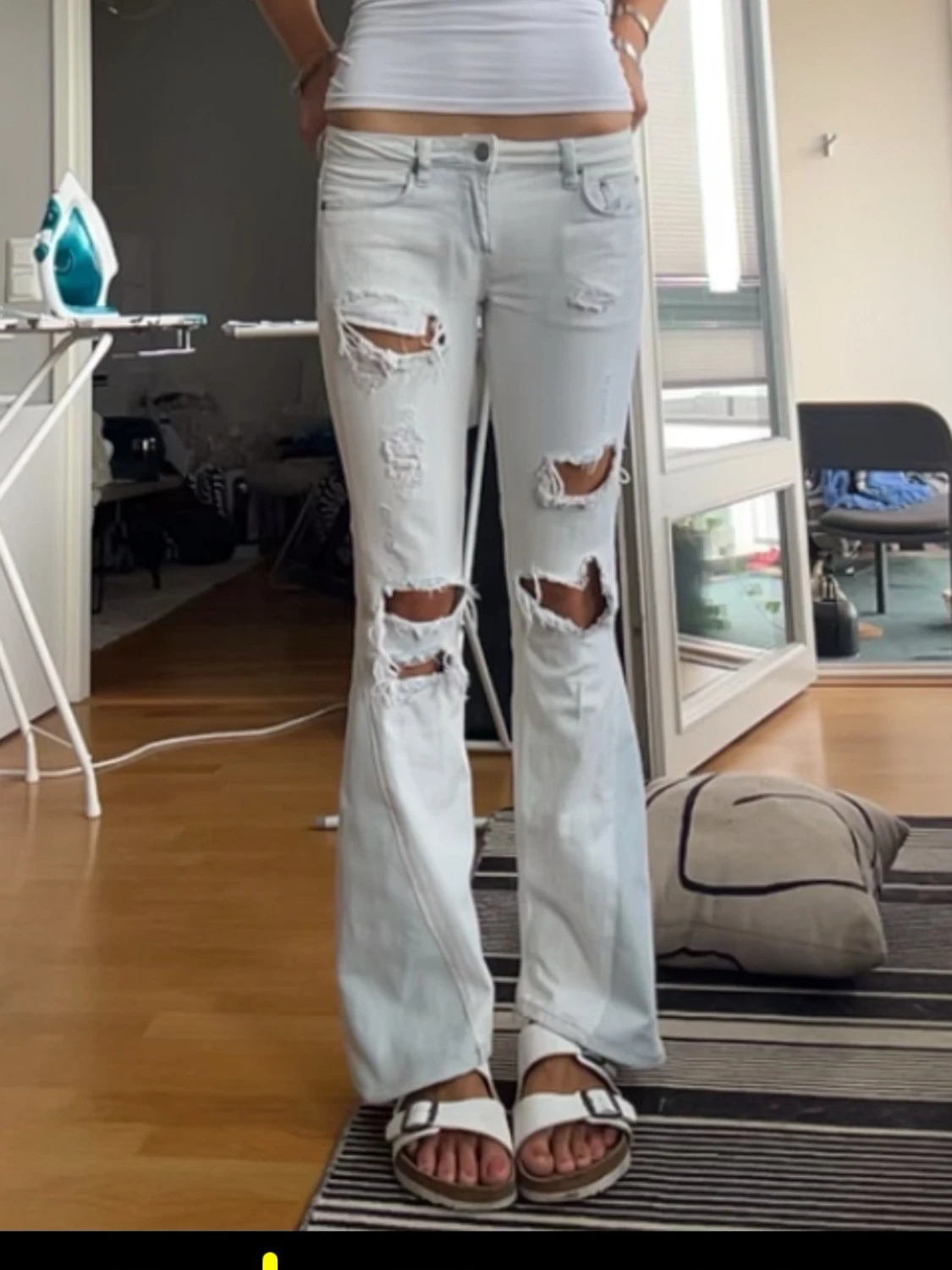 Ljusblå slitna bootcut jeans