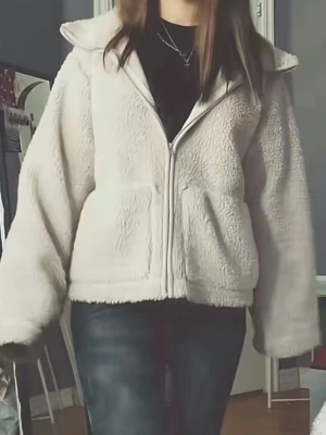 Beige teddyjacka med dragkedja - Köpte för 500 säljer för 250 Mysig beige teddyjacka med huva och dragkedja framtill. Jackan har två stora fickor och en avslappnad, boxig passform. Perfekt för att hålla värmen under kyliga dagar. Materialet är fluffigt och mjukt, vilket ger en trendig och bekväm look.