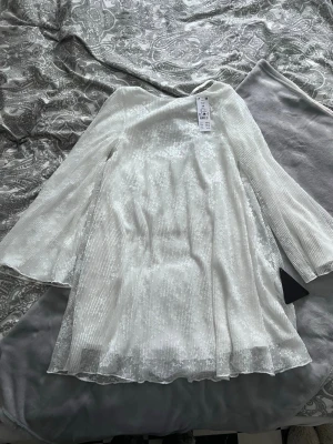 Vit klänning - Vit klänning med fint mönster och spetsdetaljer från Gina Tricot i storlek xs. Så fin till student, skolavslutning eller bröllop. Helt ny med prislapp. Nypris 600kr. Köp gärna bundle så kan vi komma överens om ett bra paketpris! Är just nu fri frakt så passa på!