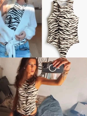 Zebramönstrad body - Säljer en snygg ärmlös bodysuit med zebramönster i svart och vitt. Bodyn har rund halsringning och är figurnära i modellen. Perfekt att styla med jeans eller kjol för en trendig look.