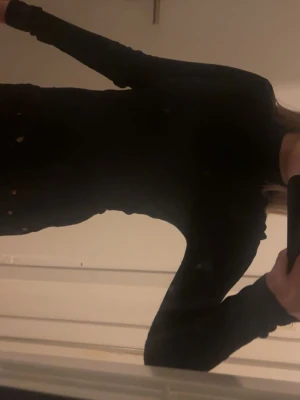 Svart ribbad långärmad topp - Säljer en svart ribbad långärmad topp med tight passform. Tyget är stretchigt och mjukt, perfekt för att styla med olika outfits. Enkel och stilren design utan synliga detaljer eller mönster. Den glittrar även lite ✨ 