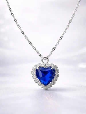 Halsband med blå hjärtformad sten - Snyggt halsband i rostfritt stål med en stor, blå hjärtformad sten som hänge. Runt stenen sitter gnistrande klara stenar som ger extra bling. Kedjan har ett elegant mönster och justerbar längd. Perfekt accessoar för dig som vill sticka ut.