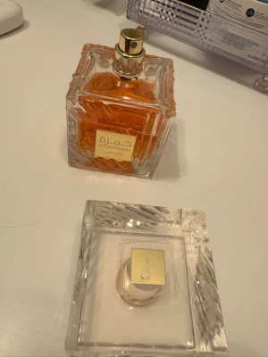Lattafa Khamrah parfym, fyrkantig flaska - Lattafa Khamrah parfym i en elegant, fyrkantig glasflaska med guldigt spruthuvud och detaljer. Flaskan är genomskinlig. Helt äkta vinterparfym vill inte ha den mera  och den passar perfekt för fester inte så stark och inte så svagt medans perfekt men så gott. DEN ÄR ANVÄND MEN HAR MER ÄN HALVA!