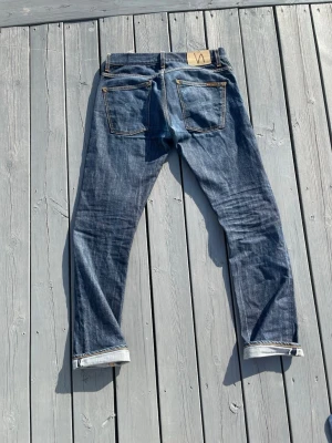 Nudie jeans Grim Tim Open Dry Selvage - Snygga Nudie jeans i modellen Grim Tim i Open Dry Selvage! Snygga fades, storlek 31/34! Hör av dig vid frågor!