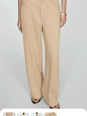 Mango Beiga vida linnebyxor - Snygga beiga linnebyxor med hög midja och raka, vida ben. Byxorna har fickor fram och bak och är tillverkade i ett lätt och luftigt linnematerial som passar perfekt till sommaren. Matcha med en crop top eller skjorta för en chill look.