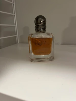 Stronger with you intensly - En exklusiv parfym från Armani , i en elegant fyrkantig glasflaska med rundad silverfärgad kork. Flaskan har en klassisk och tidlös design som passar perfekt på parfymhyllan. Ungefär 35-40ml kvar