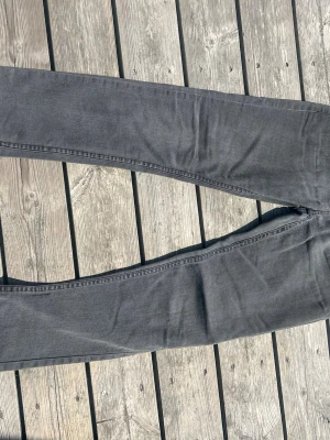 Levi's 512 Slim Taper grå jeans, stl 164 - Säljer ett par grå Levi's 512 Slim Taper jeans med smal passform och avsmalnande ben. Klassisk femficksmodell i mjukt denimtyg. Perfekta för dig som gillar en modern och clean look.