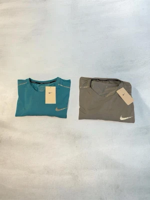 Nike miler t-shirts  - Hej!  Säljer två Nike Miler T-shirts i storlek 2XL. De är dock små i storleken och passar bäst dig som normalt bär L.  Jag brukar själv ha S/M och på mig var de bara lite för stora. Därför skulle jag säga att de passar en person som normalt har L allra bäst. 🏷️ Rabatt vid köp av flera plagg!   📦 Skickas inom 24 timmar 🚚