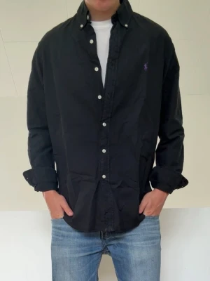 Svart Ralph Lauren skjroya - Svart Ralph Lauren skjorta i strl L men sitter som en M! Bra skick utan nåra defekter och och hör gärna av er vid frågor elr funderingar!!