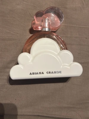 Ariana Grande Cloud Eau de Parfum - Säljer en Ariana Grande Cloud Eau de Parfum, 100 ml. För att jag inte använder den längre. :), använd fåtal gånger som man ser. Perfekt för dig som gillar fruktiga dofter med en snygg design🥰
