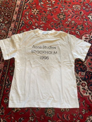 Acne studios T-shirt  - Den eftertraktade Acne studios T-shirt, som har blivit extremt populär! Särskilt till sommarn är den stilig. Storlek S, mycket fräscht skick. Inga tecken på användning, tveka inte att skriva vid minsta fundering. Priset sitter inte i Sten 🤝