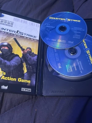Counter-Strike Condition Zero PC-spel - Säljer Counter-Strike Condition Zero till PC, ett klassiskt actionspel från Valve. Spelet kommer i original plastfodral med två blå CD-skivor och omslag med taktiska figurer. Perfekt för dig som gillar FPS och multiplayer.