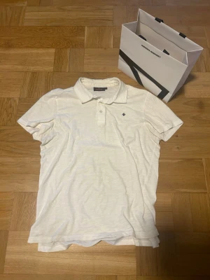 Vit pikétröja från Morris - Säljer en vit Morris piké, storlek M. Köptes för någon månad sen men knappt kommit till användning tyvärr. Väldigt bra skick på pikén, inga synliga tecken på användning. OBS! Påsen i bilderna följer inte med vid köp av tröjan. Bara att höra av sig vid frågor mm!