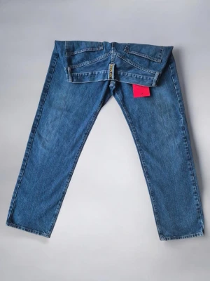 Replay Straight Fit Jeans W34 L30 - Mörkblå Premium Denim - Replay Straight Fit Jeans W34 L30 – Mörkblå Premium Denim Snygga och klassiska jeans från Replay i rak passform (straight fit). En tidlös modell som passar perfekt för både vardag och mer stilrena outfits. Jeansen har en premiumkänsla och är tillverkade i högkvalitativ denim som håller länge. Perfekta för dig som vill ha ett par stilrena märkesjeans som sitter bra och fungerar till allt. Märke: Replay Modell: Straight Fit (rak passform) Storlek: W34 L30 Färg: Mörkblå denim Skick: Mycket bra