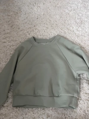 Ljusgrön tränings tjock tröja  från ONLY - En stilren ljusgrön sweatshirt från ONLY PUREBASICS i storlek XS. Tröjan har rund halsringning, långa ärmar och bred mudd vid ärmslut och nederkant. Tillverkad i mjukt bomullsmaterial som är perfekt för en avslappnad look.