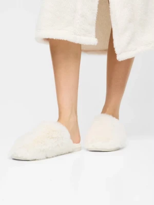 Vita fluffiga tofflor från Bik Bok - Mysiga vita tofflor från Bik Bok med supermjuk och fluffig fuskpäls. Klassisk slip-in modell med rundad tå och låg sula. Perfekta för att hålla fötterna varma hemma. 