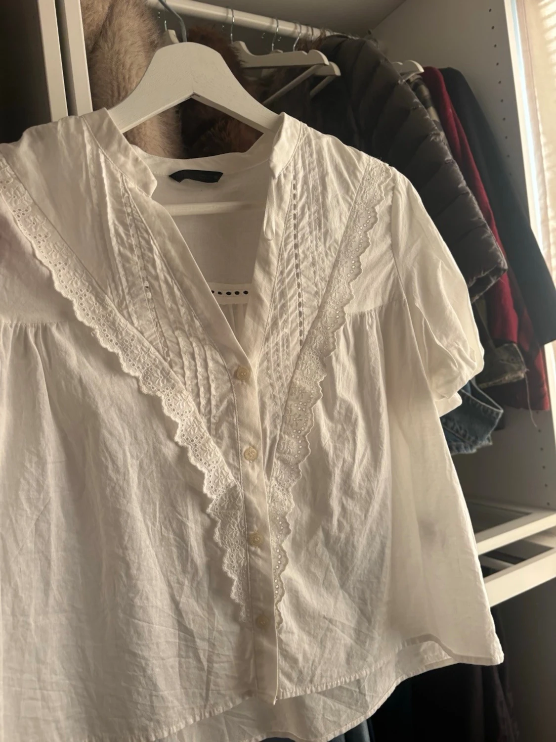 Vit blus med spetsdetaljer