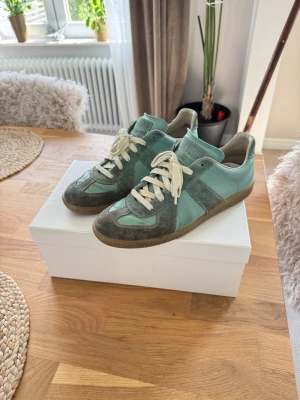 Mintgröna Maison Margiela sneakers - Maison Margiela sneakers i mintgrönt färg som är extremt sällsynt!  Storlek 43. Skicket på skorna är bra, enbart lite slitet inuti skon men inget märkvärdigt. För mer information är det bara att skriva!