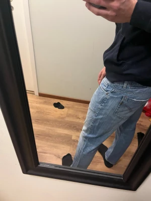 Ljusblå raka jeans Dondup - Säljer ett par ljusblå jeans med rak passform och klassisk femficksdesign. Jeansen har normal midja och subtila slitningar för en avslappnad look. Perfekta till vardagsstilen och passar till det mesta i garderoben.