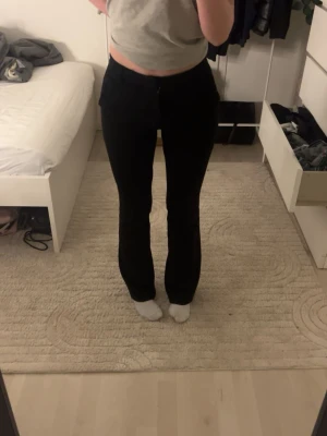 Svarta kostymbyxor  - Säljer ett par svarta kostymbyxor med rak passform och hög midja. Kostymbyxorna har klassisk femficksdesign och stängs med dragkedja och knapp. Perfekta för en stilren och enkel look.