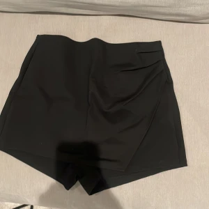 Omlottkjol - Omlottshorts som ser ut som en kjol i fram. Använd vid ett tillfälle så är i fint skick. Strl L men passar mig som i vanliga fall har M