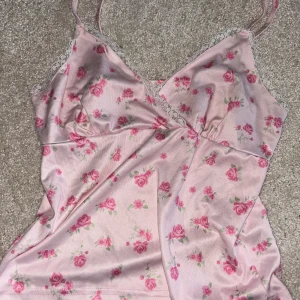 söt rosa topp - säljer denna söta rosa toppen med rosor på,köptes på plick för längesedan så har ingen aning vilket märke det är på den.Den är i storlek S!  🩷