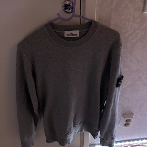 Stone island tröja - Säljer denna grå Stone island sweatshirt. Storlek S Aldrig använd och köpt på NK. Nyspris ligger på runt 3000 kr. dm för mer info