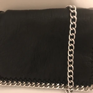 En o använd tiamo (kedje väska) - Paketet har bra skick och väskan är oanvänd, dock har den vart i en låda så den är lite skrynklig . Men när man börjar använda den kommer den formas