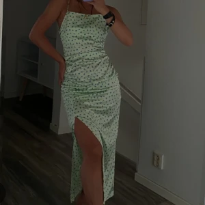 Klänning  - En grön sidenklänning från zara i storlek S. Superfin med blå blommor på och en slit på sidan. Tyvärr blivit för liten. Första och andra bilden är lånade.