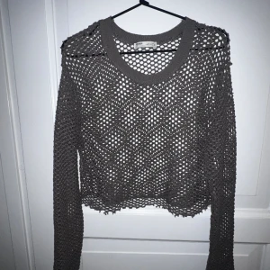 Fishnet-tröja - Långärmad ”ihålig” tröja  i stl M och lite croppad .  Skulle färgen är mer brun/grön (beroende på ljus) än grå/brun som det kanske framgår på de två första bilderna. 